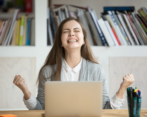 Excited female student feels euphoric celebrating online win success achievement result, young woman happy about good email news, motivated by great offer or new opportunity, passed exam, got a job